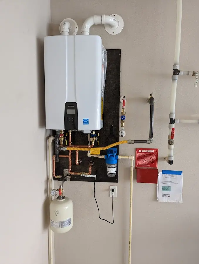 Professional plumber installing copper piping in a Edinboro home